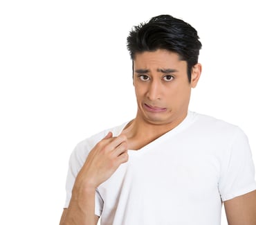 Closeup portrait of young business man opening shirt to vent, its hot, unpleasant, awkward situation, embarrassment. Isolated white background. Negative human emotions, facial expression, feelings