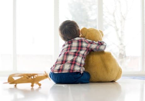 Little child sitting in living room with teddy bear-1