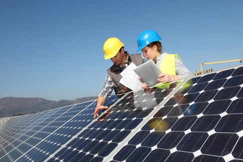 Man showing solar panels technology to student girl-1