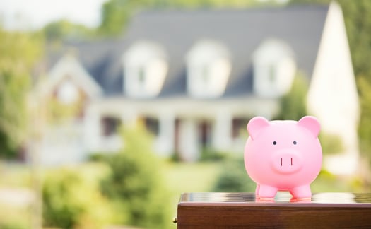 Real estate sale, home savings, loans market concept. Housing industry mortgage plan and residential tax saving strategy. Piggy bank isolated outside home on background. Focus on piggybank. Homeowner-2