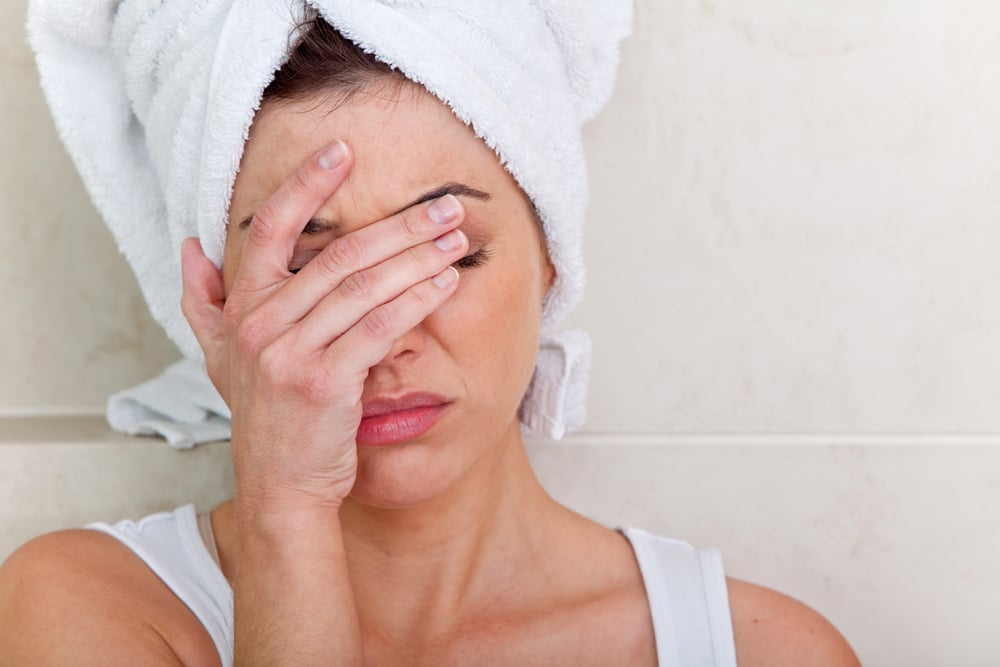 Beautiful woman after a bath having a headache