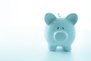 Ceramic blue piggy bank with copy space on white background