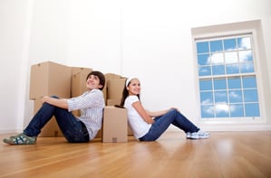 Couple with cardboard boxes moving to a new house