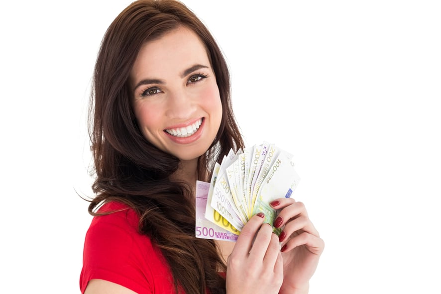 Happy brunette holding her cash money on white background